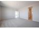 Bedroom with neutral carpet and paint and an open view to a bathroom at 22035 N Rummler Ln, Maricopa, AZ 85138