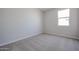 Comfortable bedroom featuring soft carpeting, neutral walls, and a sunlit window at 22035 N Rummler Ln, Maricopa, AZ 85138