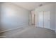 Spacious bedroom with plush carpeting and generous closet space at 22035 N Rummler Ln, Maricopa, AZ 85138