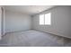 Carpeted bedroom with a large window allowing for ample natural light at 22035 N Rummler Ln, Maricopa, AZ 85138