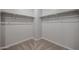 Walk in closet interior with installed racks and shelves at 22035 N Rummler Ln, Maricopa, AZ 85138