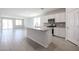Open-concept kitchen featuring granite countertops, an island, and stainless steel appliances at 22035 N Rummler Ln, Maricopa, AZ 85138