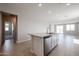Bright kitchen island boasts a speckled granite countertop and stainless steel dishwasher in an open-concept space at 22035 N Rummler Ln, Maricopa, AZ 85138