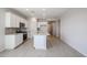 Modern kitchen features white cabinets, granite countertops, stainless steel appliances, and stylish tile flooring at 22035 N Rummler Ln, Maricopa, AZ 85138