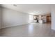 Bright and airy living room with tiled floors and views into the kitchen and entry at 22035 N Rummler Ln, Maricopa, AZ 85138