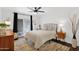 Cozy bedroom with wood floors, an area rug, shiplap accent wall, and a sliding glass door at 2219 E Catalina Dr, Phoenix, AZ 85016