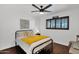 Bedroom with a ceiling fan, wood floors, and an accent window with the word 'FAITH' at 2219 E Catalina Dr, Phoenix, AZ 85016