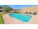 Community pool with turquoise-blue water and surrounding lounge chairs, perfect for relaxing and enjoying the sunny weather at 2219 E Catalina Dr, Phoenix, AZ 85016