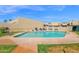 Community pool surrounded by green space and lounge chairs, inviting residents to unwind and enjoy outdoor leisure at 2219 E Catalina Dr, Phoenix, AZ 85016