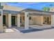 Stylish home featuring a covered parking area with decorative beams and an arched window by the front door at 2219 E Catalina Dr, Phoenix, AZ 85016