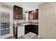 Traditional-style kitchen with dark wood cabinets, granite countertops, and white appliances provides ample workspace at 2219 E Catalina Dr, Phoenix, AZ 85016