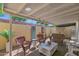 Charming covered patio with brick flooring, wicker furniture, and a cozy outdoor living space at 2219 E Catalina Dr, Phoenix, AZ 85016