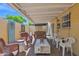 Serene covered patio with a combination of wicker and plastic furniture for versatile outdoor relaxation and entertainment at 2219 E Catalina Dr, Phoenix, AZ 85016