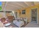 Inviting covered patio with comfortable seating, a white table, and charming decor at 2219 E Catalina Dr, Phoenix, AZ 85016