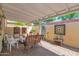 Inviting covered patio with brick flooring, wicker seating, and a serene ambiance for relaxed outdoor gatherings at 2219 E Catalina Dr, Phoenix, AZ 85016