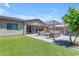 A backyard features artificial turf, a pergola, and hot tub, creating the perfect outdoor retreat at 22977 E Desert Spoon Dr, Queen Creek, AZ 85142