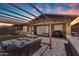 Backyard patio with outdoor seating, grill, and a fire pit for relaxing evenings outside at 22977 E Desert Spoon Dr, Queen Creek, AZ 85142
