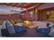 Relaxing backyard featuring a fire pit, comfortable seating, and a peaceful ambiance at dusk at 22977 E Desert Spoon Dr, Queen Creek, AZ 85142