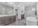 Spacious bathroom with a soaking tub, modern vanity, walk-in shower, and lots of natural light at 22977 E Desert Spoon Dr, Queen Creek, AZ 85142