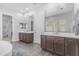 Modern bathroom featuring dual vanities, wood-look tile flooring, and bright neutral decor at 22977 E Desert Spoon Dr, Queen Creek, AZ 85142