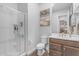 Modern bathroom featuring a glass-enclosed shower, toilet, and a stylish vanity with artwork at 22977 E Desert Spoon Dr, Queen Creek, AZ 85142