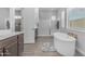 Bright bathroom featuring a soaking tub, walk-in shower, vanity, and lots of natural light at 22977 E Desert Spoon Dr, Queen Creek, AZ 85142