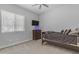 Bedroom featuring TV, dresser, and large bright window with blinds at 22977 E Desert Spoon Dr, Queen Creek, AZ 85142