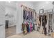 Spacious walk-in closet with ample hanging space and open access to a utility room at 22977 E Desert Spoon Dr, Queen Creek, AZ 85142