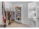 Well-organized walk-in closet featuring open shelving and access to ensuite bath at 22977 E Desert Spoon Dr, Queen Creek, AZ 85142