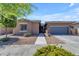 Lovely single-Gathering home with a well-kept lawn, charming curb appeal, and inviting entryway at 22977 E Desert Spoon Dr, Queen Creek, AZ 85142