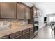 Gourmet kitchen featuring granite countertops, stainless steel appliances, and ample storage at 22977 E Desert Spoon Dr, Queen Creek, AZ 85142