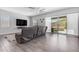 Relaxing living room with modern tile flooring and a sliding glass door to the outdoor patio at 22977 E Desert Spoon Dr, Queen Creek, AZ 85142