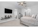 Bright and airy main bedroom with a TV, modern decor, and an ensuite bathroom at 22977 E Desert Spoon Dr, Queen Creek, AZ 85142