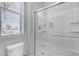 Bright bathroom featuring a modern glass-enclosed shower and a window providing natural light at 22977 E Desert Spoon Dr, Queen Creek, AZ 85142