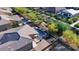 An aerial view showcasing the backyard oasis with pool, green spaces, and patio at 24042 N 170Th Ln, Surprise, AZ 85387