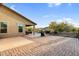 Inviting backyard with brick pavers, covered patio, built-in BBQ and lush green landscaping at 24042 N 170Th Ln, Surprise, AZ 85387