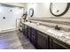 Elegant bathroom featuring double sinks, granite countertops, and a spacious glass-enclosed shower at 24042 N 170Th Ln, Surprise, AZ 85387