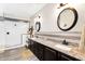 The primary bathroom features double sinks, granite countertops, and a seamless glass shower at 24042 N 170Th Ln, Surprise, AZ 85387