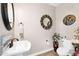 Elegant powder room featuring modern fixtures, decorative mirror, and convenient commode at 24042 N 170Th Ln, Surprise, AZ 85387