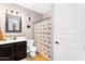 Charming bathroom featuring a vanity, toilet, and shower with colorful bird-themed curtain at 24042 N 170Th Ln, Surprise, AZ 85387