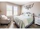 Cozy bedroom featuring soft colors, two windows, and decorative accents at 24042 N 170Th Ln, Surprise, AZ 85387