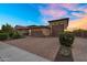 Paver driveway to garages of a charming home with desert landscaping and vibrant sky at 24042 N 170Th Ln, Surprise, AZ 85387