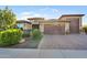 Inviting single-story home with desert landscaping and a three-car garage at 24042 N 170Th Ln, Surprise, AZ 85387