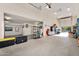 Spacious garage with storage shelving and ample room for vehicles and projects at 24042 N 170Th Ln, Surprise, AZ 85387