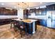 A modern kitchen features an island with seating, stainless steel appliances, and granite countertops at 24042 N 170Th Ln, Surprise, AZ 85387