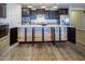 Spacious kitchen island with hidden storage, granite counters, dark cabinets, and stainless steel appliances at 24042 N 170Th Ln, Surprise, AZ 85387