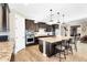 A modern kitchen with stainless steel appliances, a large island, dark wood cabinets and a breakfast bar at 24042 N 170Th Ln, Surprise, AZ 85387
