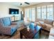 Cozy living room with modern furniture, including a plush sofa and patterned armchairs at 24042 N 170Th Ln, Surprise, AZ 85387
