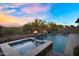 Sparkling pool and hot tub area with fire bowls and desert scenery at 24042 N 170Th Ln, Surprise, AZ 85387