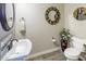 Charming powder room with decorative mirrors, pedestal sink, and tiled accents at 24042 N 170Th Ln, Surprise, AZ 85387